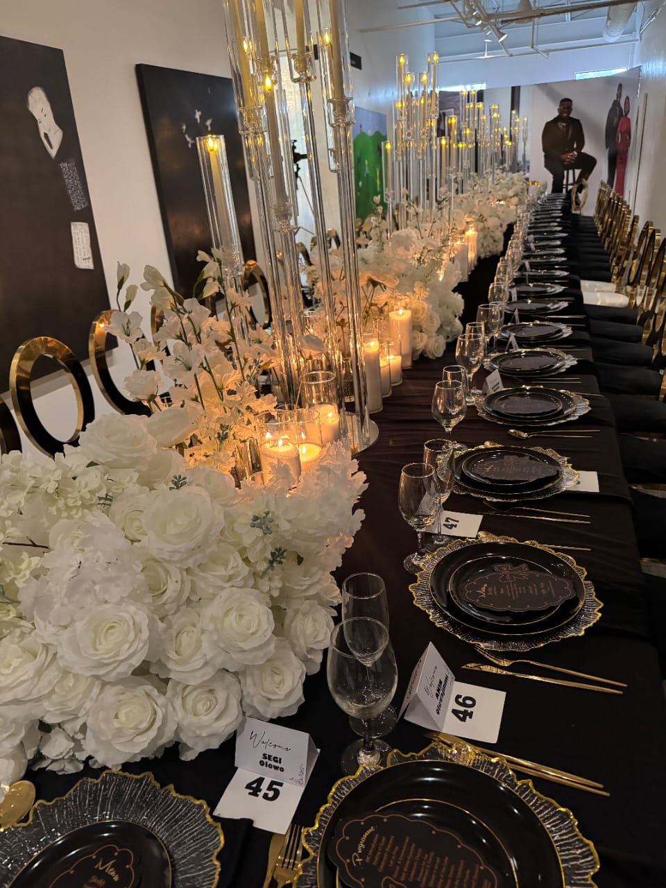 Floral backdrop installation with candlelight and draped fabric