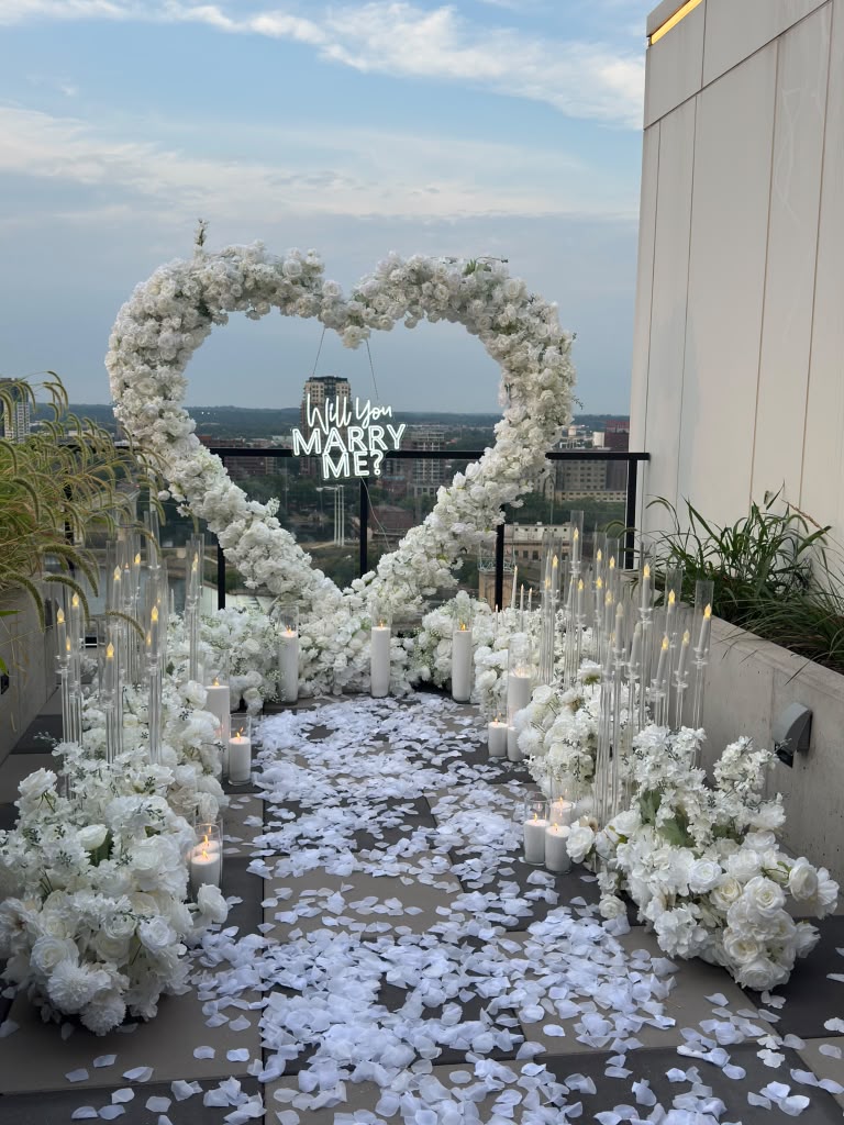 White floral heart proposal setup overlooking the city